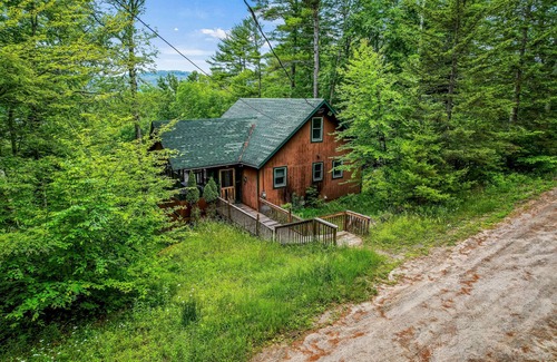 Brant Lake House | Secluded cabin with dock, wraparound deck, gorgeous view & enclosed porch