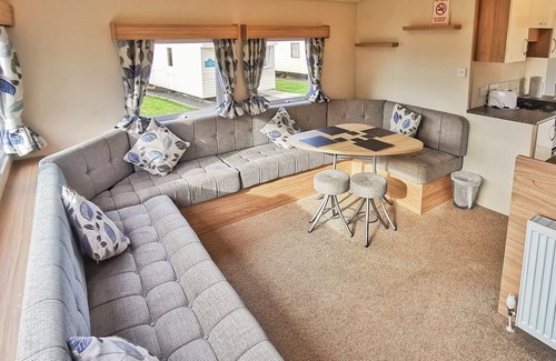 Llanllwchaiarn House | Spacious and well presented, 12-ft wide caravan with one double and one twin bedroom.