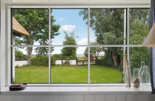Vejlby Fed House | Spend a wonderful vacation in this comfortable cottage overlooking the sea from the property.