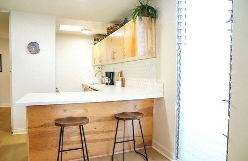 Mission Hills Apartment | Step inside this home and discover a unique blend of mid-century retro-chic, where classic design meets a lively, modern sensibility with clean lines, warm woods, and pops of vibrant color that transport you to a cooler, more carefree era.