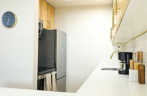 Mission Hills Apartment | Step inside this home and discover a unique blend of mid-century retro-chic, where classic design meets a lively, modern sensibility with clean lines, warm woods, and pops of vibrant color that transport you to a cooler, more carefree era.