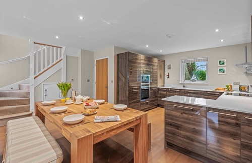 Talland House | Stylish and contemporary pet friendly property featuring a wood-burning stove, patio hot tub and lar