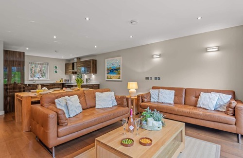 Talland House | Stylish and contemporary pet friendly property featuring a wood-burning stove, patio hot tub and lar