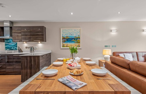 Talland House | Stylish and contemporary pet friendly property featuring a wood-burning stove, patio hot tub and lar