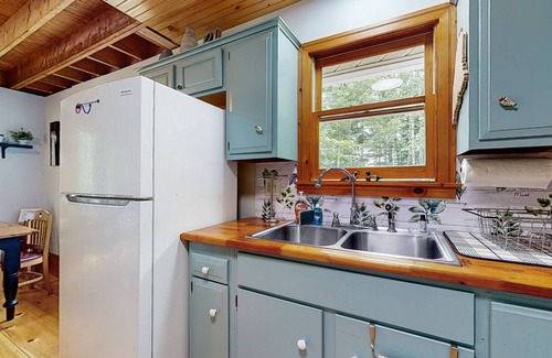 Warren House | Sunny, lakefront home on South Pond with private dock, great deck & firepit