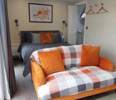 Amroth Apartment | The Den - Modern cabin with wood burning stove