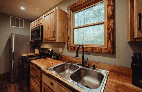 South Bloomingville Cabin | The Edge - Escape to The Edge Cabin in Hocking Hills, OH! This cozy retreat features a private hot tub, fire pit, gas grill, and more. Perfect for up to 6 guests, it’s minutes from hiking, waterfalls, and caves. Book your stay today!