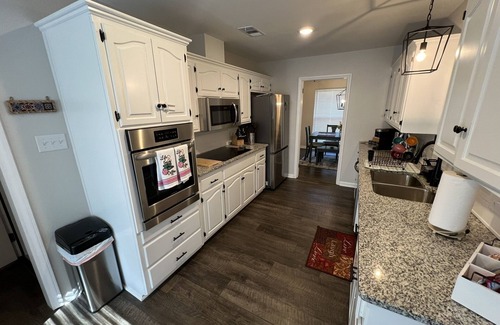 Fort Smith House | The Lily Pad. 3 bd/1ba. 4 beds. Center of town! Fenced backyard!