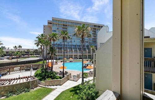 South Padre Island House | The ocean waves are calling! Relaxing setting with pool view in beachfront resort
