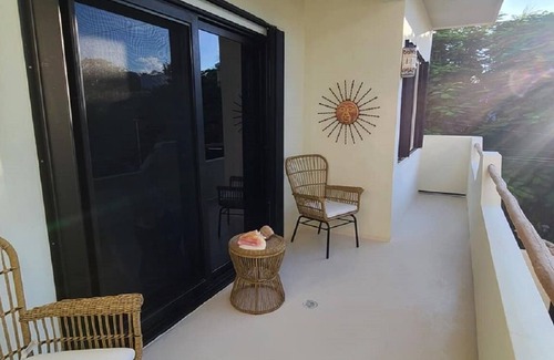 Isla Mujeres Apartment | The Sol Studio Suite with balcony overlooking the pool and garden area