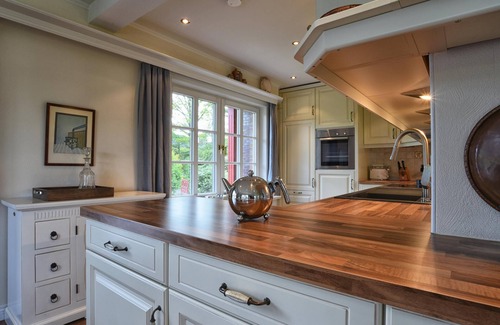 Nieblum House | The thatched-roof vacation home has 3 bedrooms and 2 bathrooms, and offers a large living area.