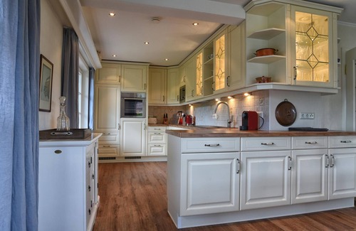 Nieblum House | The thatched-roof vacation home has 3 bedrooms and 2 bathrooms, and offers a large living area.