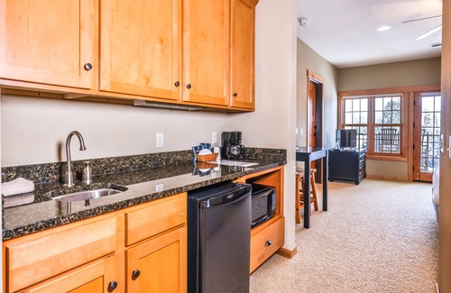 Three Lakes Condo | Third-floor studio with lake view, kitchenette, balcony, hot tubs, pool, & gym
