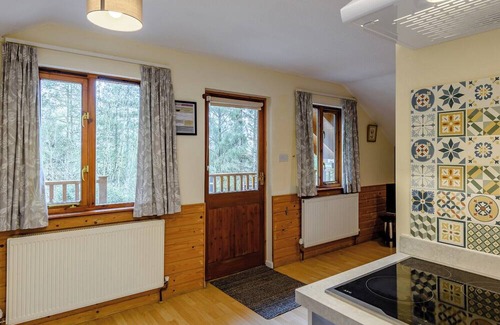 Westleigh Ski Chalet | Timber lodge set in an elevated woodland position with views of the lake.