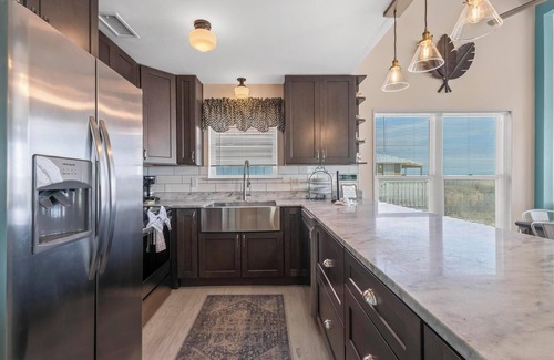 Fort Morgan House | Totally renovated 4 bedroom, 3 bath gulf front home with nice covered deck and large sun room.