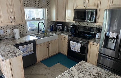 Palm City Cottage | Tropical Getaway! Waterfront Bungalow with Heated Pool, Firepit, & Kayaks