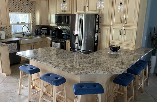 Palm City Cottage | Tropical Getaway! Waterfront Bungalow with Heated Pool, Firepit, & Kayaks