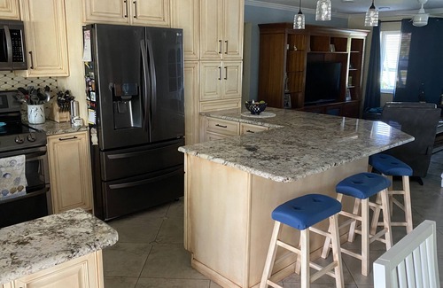 Palm City Cottage | Tropical Getaway! Waterfront Bungalow with Heated Pool, Firepit, & Kayaks