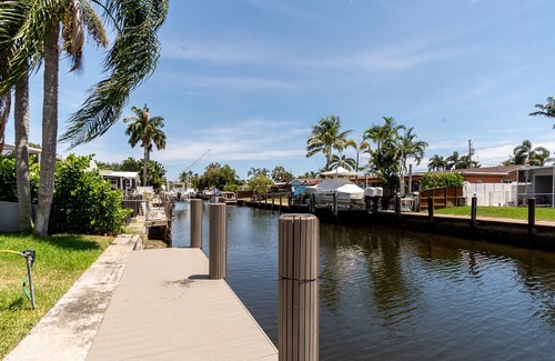 Melaleuca Gardens House | Tropical oasis with canal views. A fishing adventure near the beach!