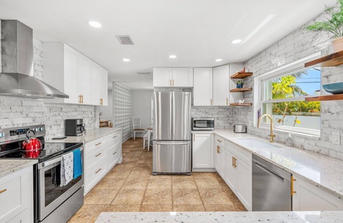 Seacoast Shores House | Tropical Retreat: Indian Harbour Beach Home with BBQ Grill, Fire Pit, Private Pool & Hot Tub! 🌴