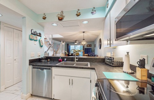 Inverness House | Two-story townhome with lake access, pool, bbq grill, screened patio
