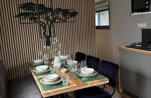 Lieren House | Veluwe Chalet featuring a charming veranda with a fire table.