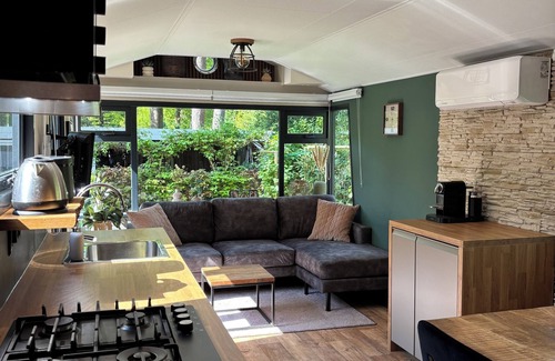 Lieren House | Veluwe Chalet featuring a charming veranda with a fire table.