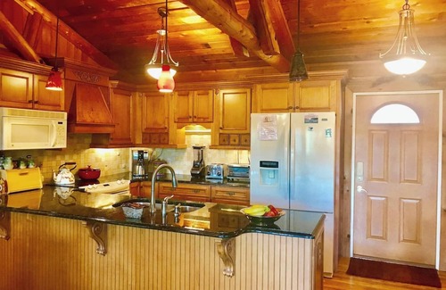 Huddleston House | Views from upscale hm are of trees, beautiful gardens, mountains & lake. Two Decks are stunning