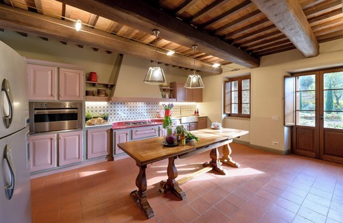 Torricella Villa | Villa Lago is set against a hillside of luscious greenery olive groves