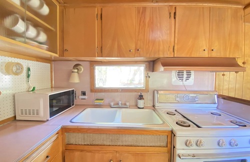 Kernville House | Vintage wood paneled travel trailer on Kernville Ranch: horses, river, hot tub