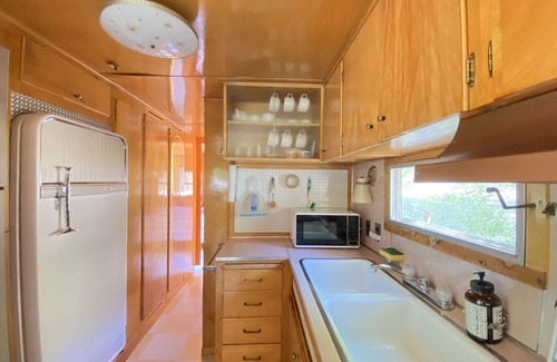 Kernville House | Vintage wood paneled travel trailer on Kernville Ranch: horses, river, hot tub