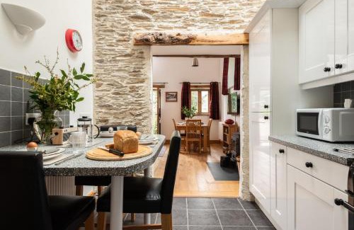 Widegates House | Water Mill at East Trenean Farm -Luxury Cornish Cottage sleeping 4 with hot tub, private garden, rural views and EV facilities