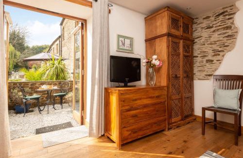 Widegates House | Water Mill at East Trenean Farm -Luxury Cornish Cottage sleeping 4 with hot tub, private garden, rural views and EV facilities
