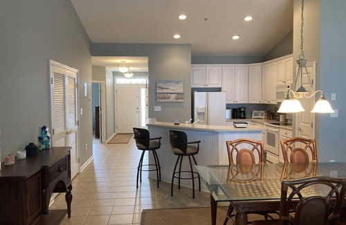 Sunset Island Condo | Waterfront condo with balcony, fireplace, AC, W/D, WiFi, indoor & outdoor pools