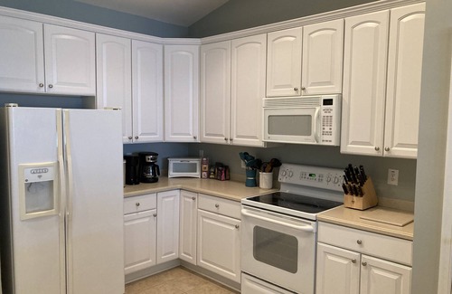 Sunset Island Condo | Waterfront condo with balcony, fireplace, AC, W/D, WiFi, indoor & outdoor pools