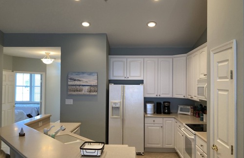 Sunset Island Condo | Waterfront condo with balcony, fireplace, AC, W/D, WiFi, indoor & outdoor pools