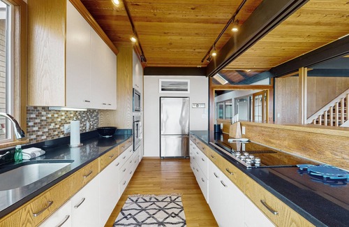 Freeland House | Waterfront family home with sandy beach and sunset views