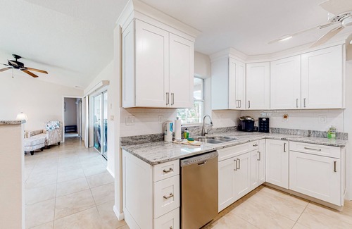 Gulf Cove House | Waterfront home with an enclosed pool, outdoor kitchen, and grill - dog-friendly