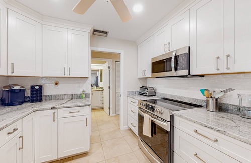 Gulf Cove House | Waterfront home with an enclosed pool, outdoor kitchen, and grill - dog-friendly