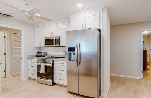 Gulf Cove House | Waterfront home with an enclosed pool, outdoor kitchen, and grill - dog-friendly
