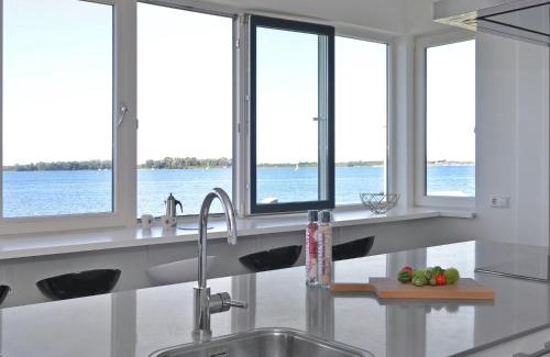 Kamperland Apartment | Waterfront penthouse with roof terrace and private jetty