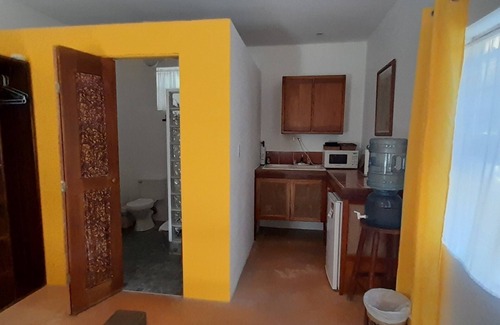 Caye Caulker Apartment | Yellow Studio - Amanda's Place - Pool and Tropical garden