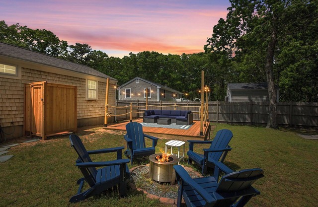 An elevated Cape Cod escape close to coveted beaches with fully fenced yard, new deck and firepit