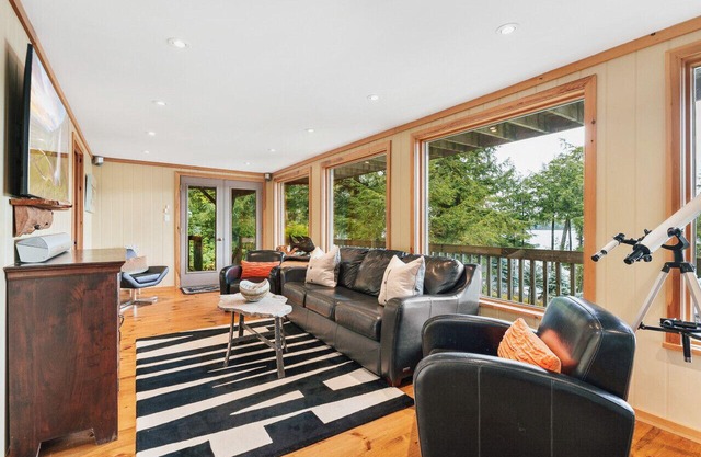 Beautifully landscaped with a sandy beach, outdoor sauna, hot-tub and ample water toys.