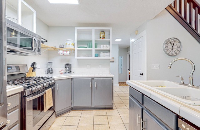 Charming home lined by trees with a large deck, grill, firepit, & pool table