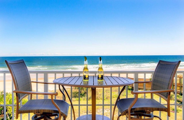 Direct oceanfront corner condo with large balcony, beachfront pool, and garage parking