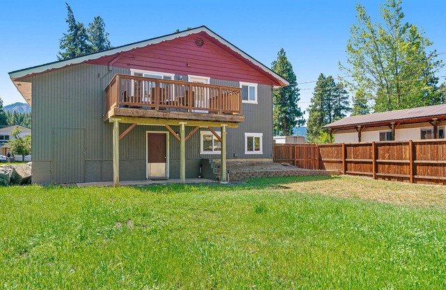 Dog-friendly two-story home near downtown with large deck, lawn, & enclosed yard