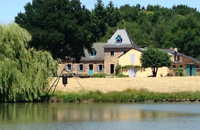 Farmhouse in the woods, on a lake shore