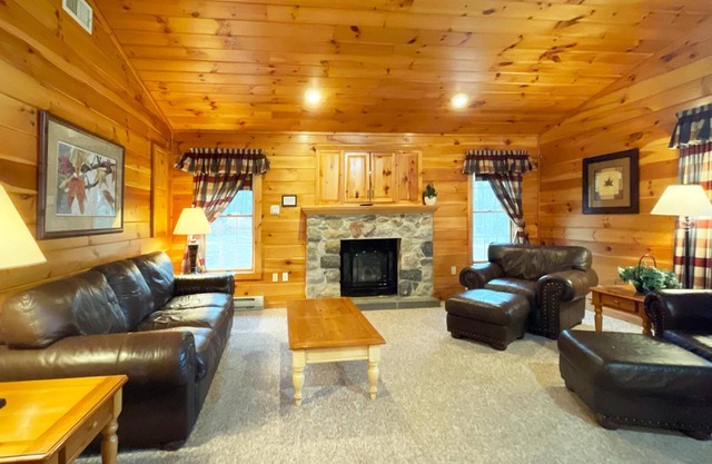 Gorgeous log cabin has a Big stone fireplace and a beautiful view of the lake