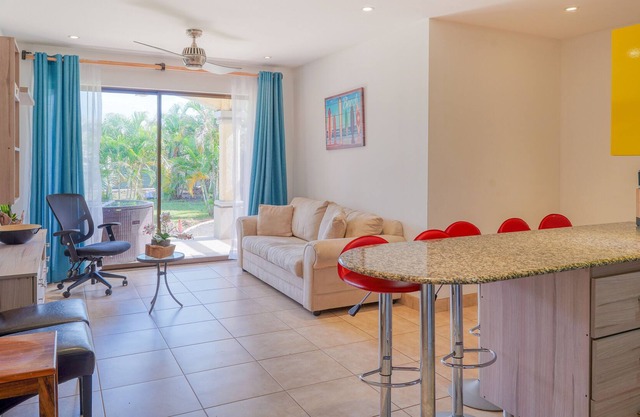 Ground-floor condo with pool & garden views, terrace, hot tub, AC, & W/D